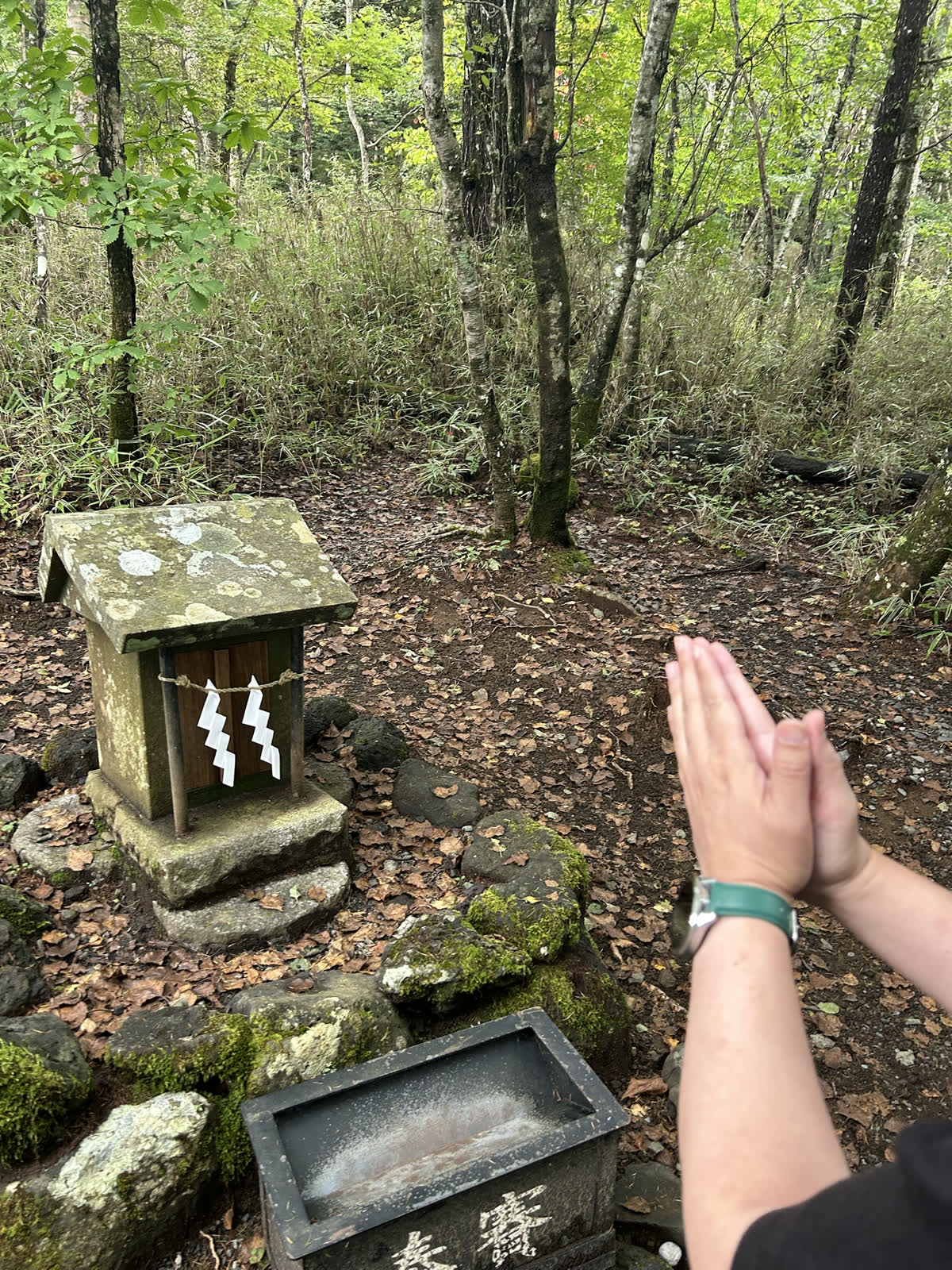 新屋山神社奥宮で手を合わせる様子